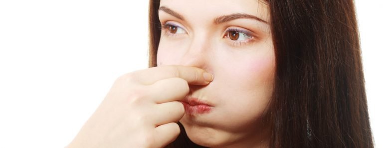 Young Woman Holding her Nose smelling something stinking popping ear 770x297 1