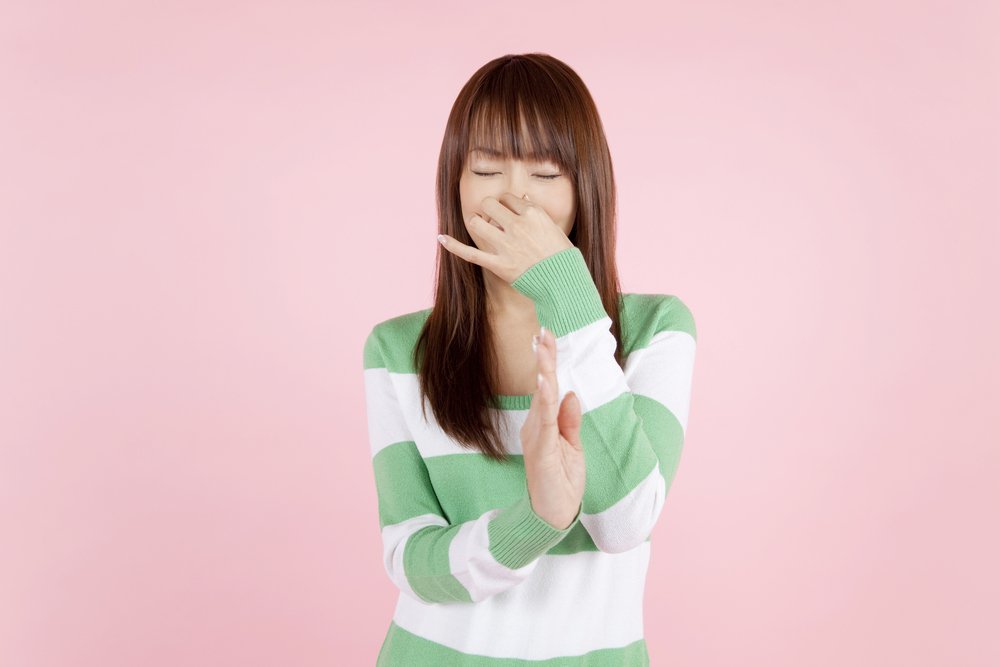 Girl pinching her nose bad smell closing nose messy dirtyKPG Paylesss