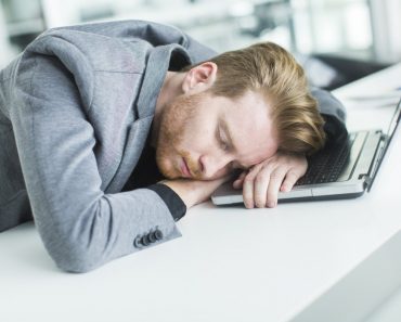 Tired young man sleeping in the office Boggy 370x297 1